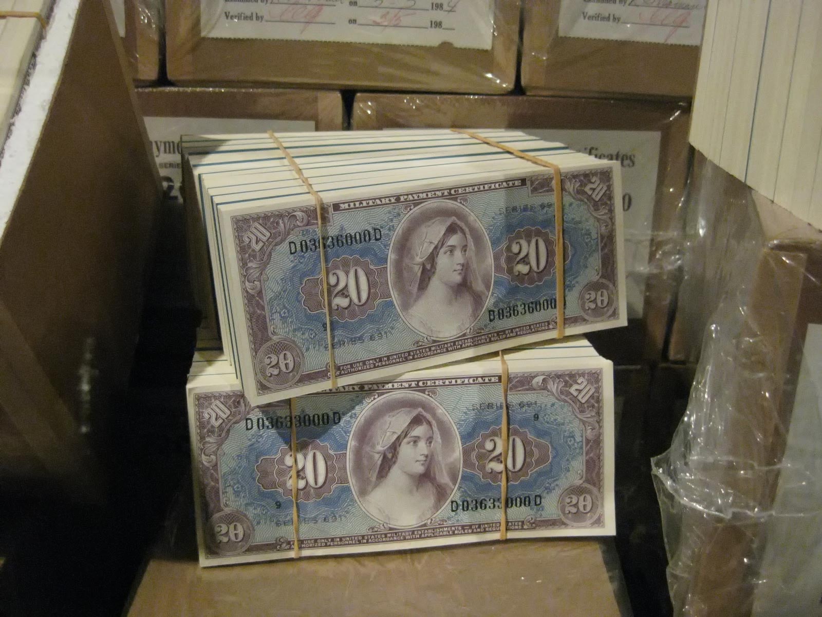 Military Payment Certificates stacked and wrapped in rubber bands.